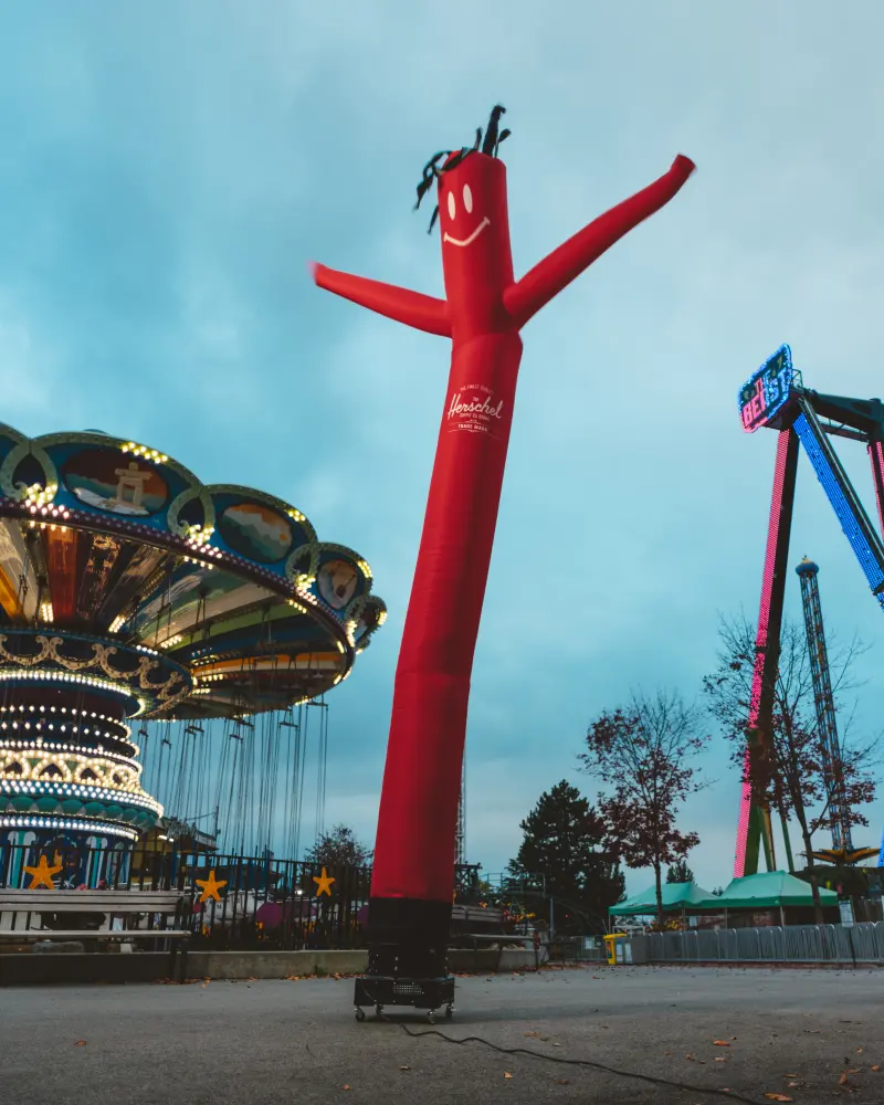 A wacky waving inflatable arm tube man standing in front of a carnival