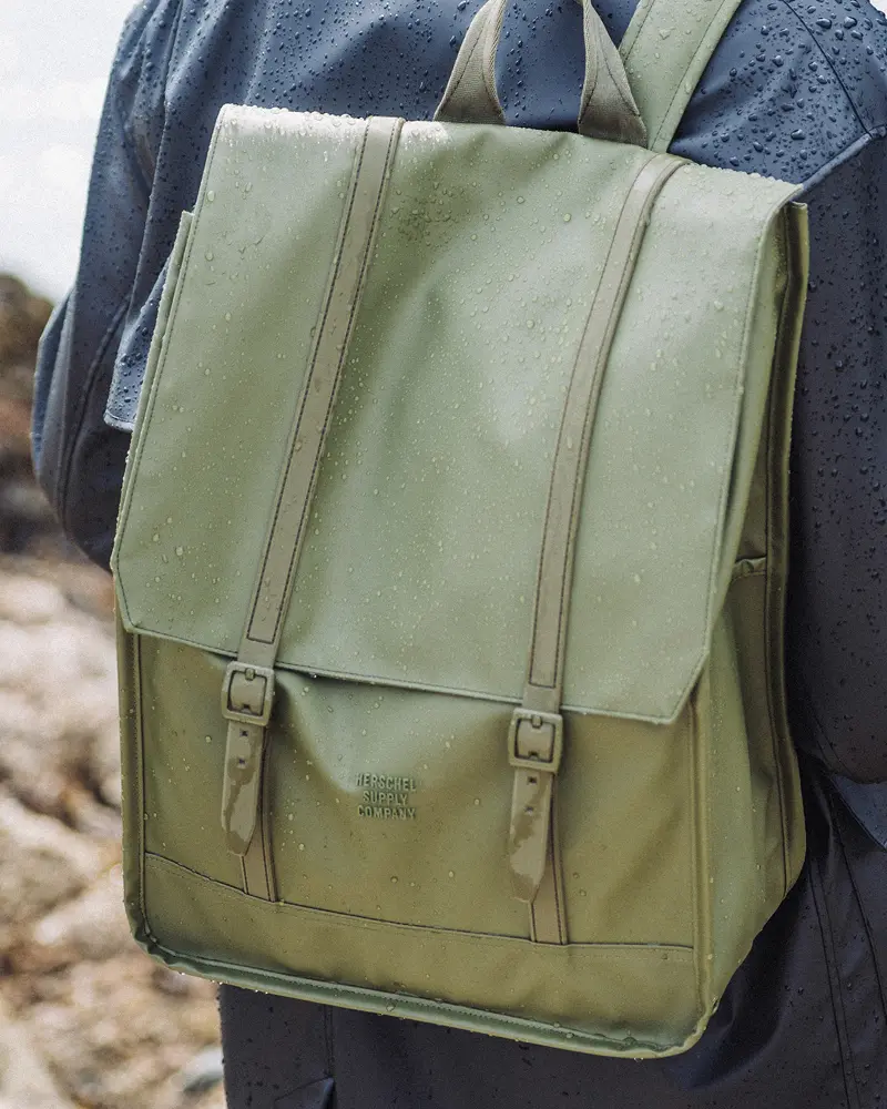 A photo of the Herschel Survey Backpack Weather Resistant in Ivy Green.