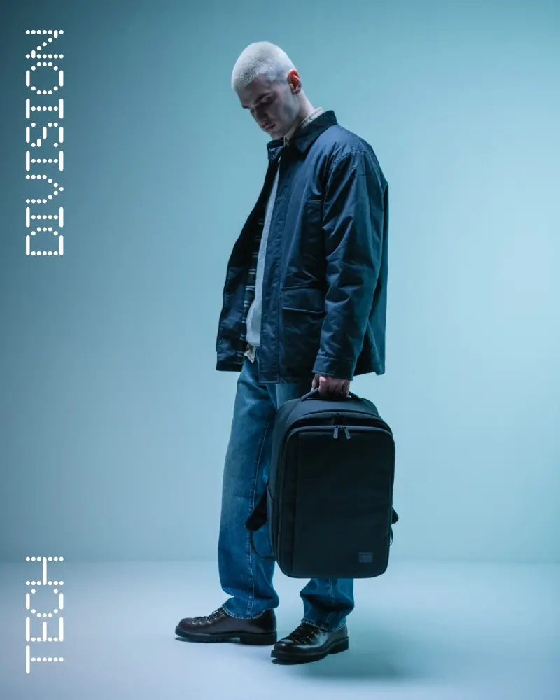 A Herschel Classic XL™ Backpack in APX™ Camo hanging off the back of an office chair